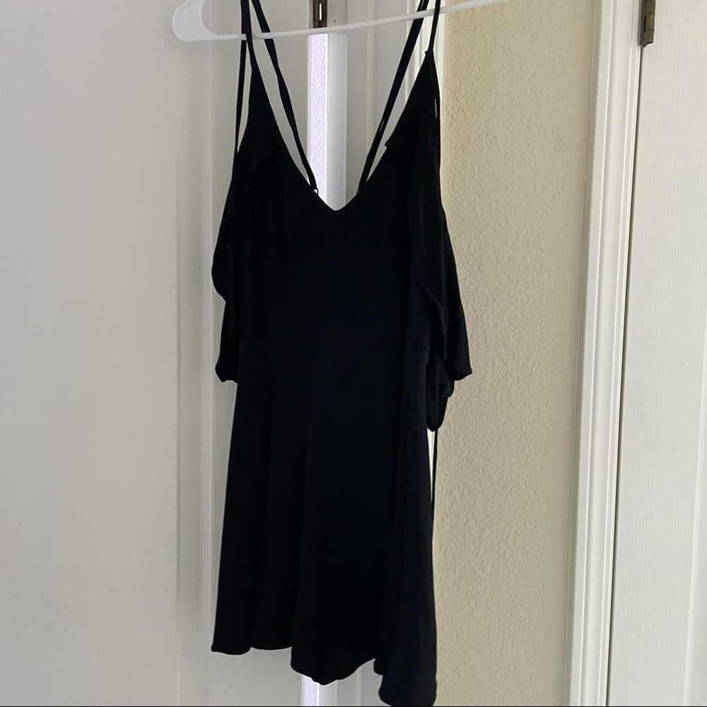 black romper with straps and ruffles